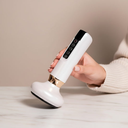 Arya Lush Dermaluxe white electric handheld body massager with gold accents held in a hand for muscle relief